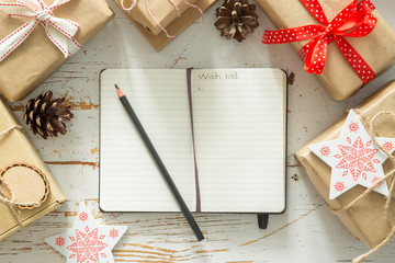 Making list of presents on wood background