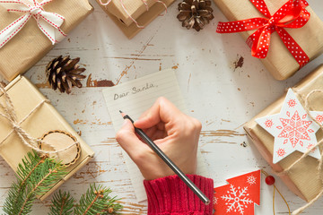 Making list of presents on wood background