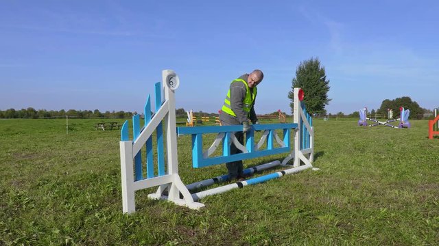 Man fix hurdle in required height