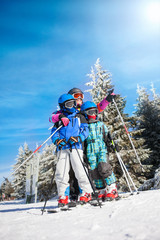  happy family ski team fun on beautiful mountain - obrazy, fototapety, plakaty