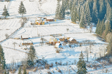 Ukrainian wooden rustic houses covered by snow
