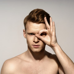 Fototapeta premium Studio fashion style closeup face portrait of young emotional man