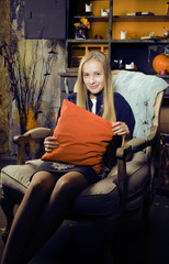 pretty blonde girl selebrating halloween in fairy interior, lifestyle happy smiling people concept
