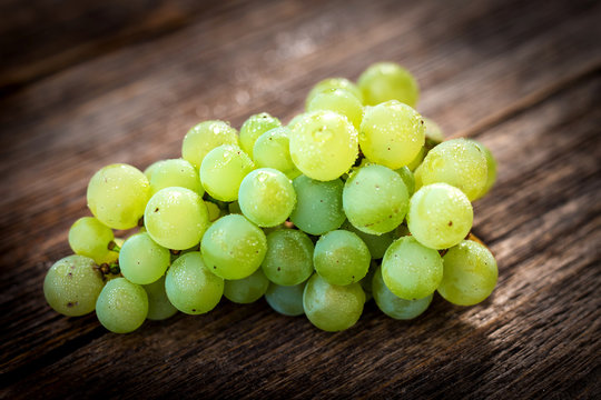 White grapes on wooden background