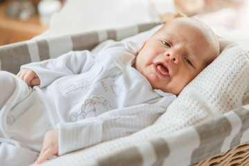 Newborn baby boy lying in a basket
