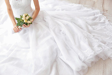 Bride in beautiful dress with wedding bouquet