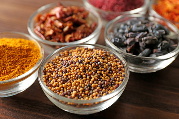 Various spices in glass bowls, close up