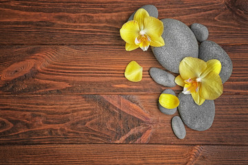 Spa stones with orchid flowers, top view