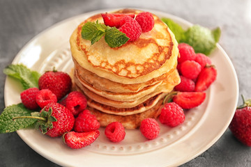 Tasty pancakes with berries on plate