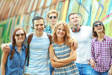 Happy friends hanging out on street