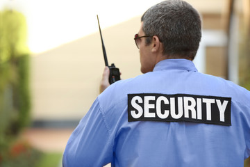 Male security guard protecting house outdoor