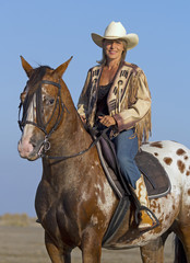 Fototapeta premium cowgirl on appaloosa horse
