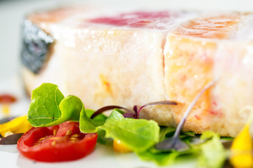 close-up grilled salmon steak slices in dish