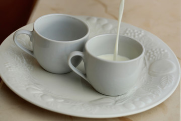 Pouring milk in cups