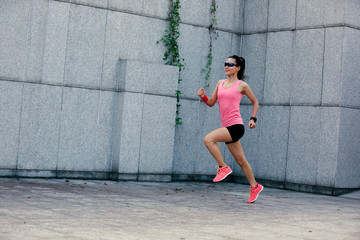 young fitness sport woman running on city