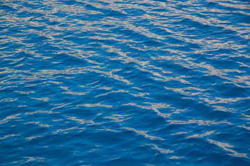 Blue water texture with some orange reflections.