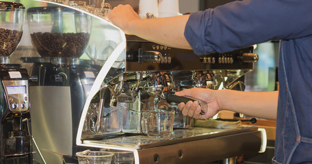 man presses the coffee for the coffee machine