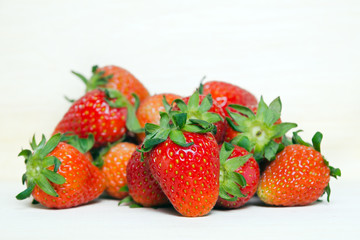 Group of of red ripe strawberry fruit on wooden board (Also know