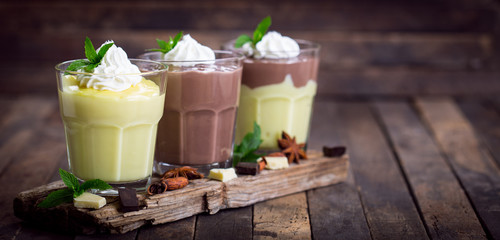 Chocolate and vanilla pudding with whipped cream