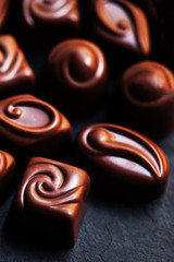 Chocolate over black background. Chocolate Candy, Cocoa. Assortm