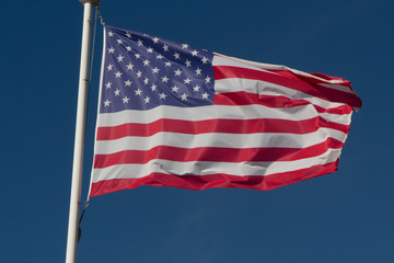 American flag on the blue sky waving