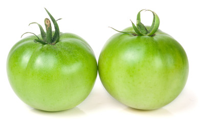Two green unripe tomato isolated on white background
