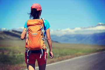 young woman hiker hiking at beautiful mountain trail