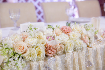 Flower garland made of pink and white roses lies on a wedding di