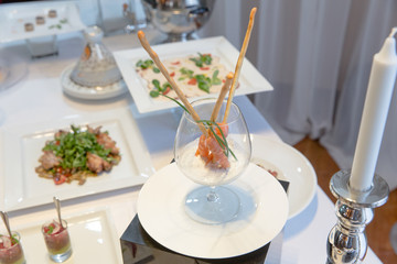 Red salmon on backed sticks served in brandy glass