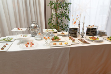 Little appetizers stand served on a buffet