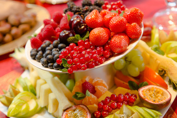 Different kinds of berries lie on the top of fruit pyramid