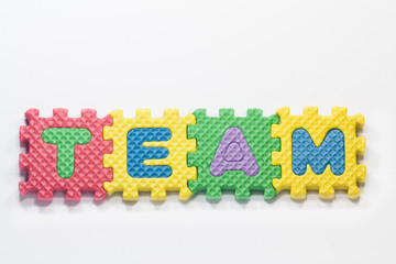 Puzzle pieces with word team on a white background.