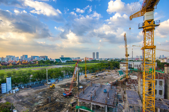 Construction site with cranes on sunset time and bangkok city background