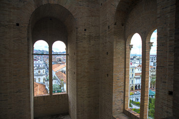 Two window openings with a view to the city below, inside the towers of the Cuenca Cathedral, Ecuador.