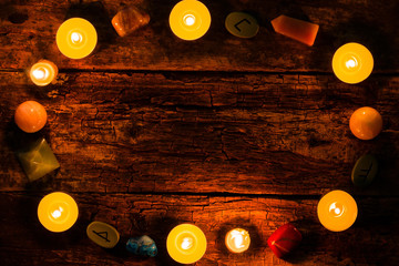 candles, stones for divination and runes on wooden background mockup