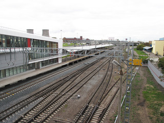Fototapeta na wymiar Railway platform and rails in a cloudy day