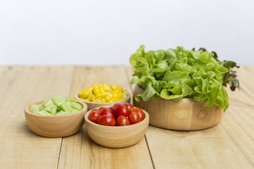 Healthy salad, fresh vegetables in wooden bowl