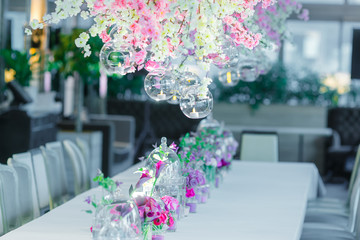 Candles burn in the glass balls above a dinner table