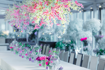 Balls with candles hang from branches with blooming flowers