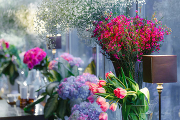 Tender tulips stand behind a little brown lamp