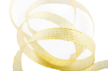 Gold satin ribbon, on a white isolated fone.Close up