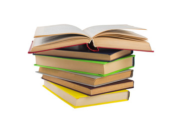 stack of multicolored books. One open. on white, isolated background.