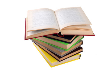 stack of multicolored books. One open. on white, isolated background.