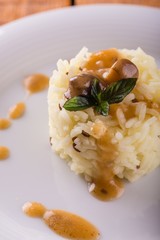 Heap of rise with sesame seads and mushroom sauce