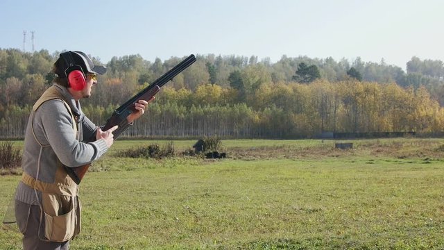 Hunter training to shoot at a target. Close up.
