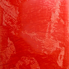 red glossy stone textured surface