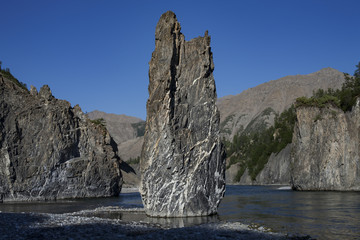 Single stone pillar in the riverbed. River Omulyovka. Magadan Region. Russia.
