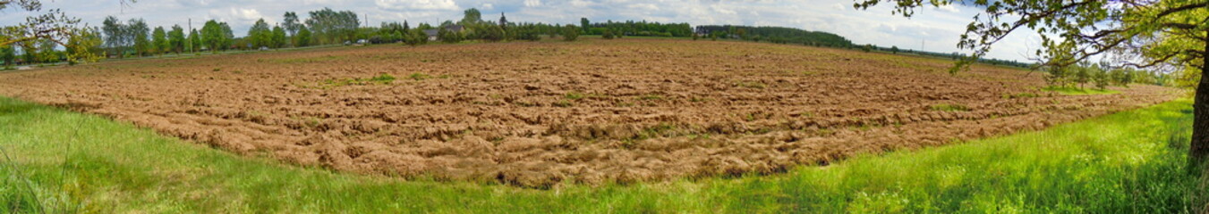 Fototapeta na wymiar Panoramic view of ploughed field