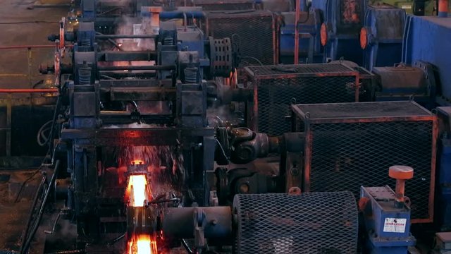 Ironworks plant. Working Machines. Borning Hot Beams. Steam