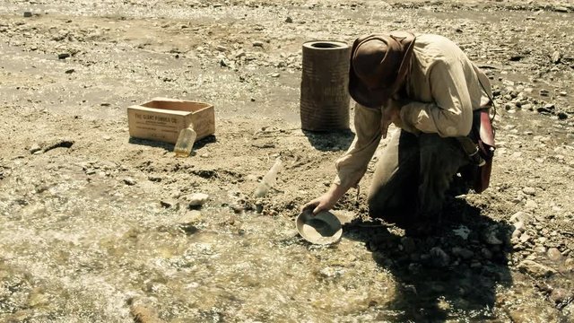 Miner Panning for Gold in a Stream